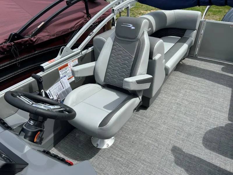 Slide: The Image of 2024 Bennington 22SSRSR boat interior with gray seating and steering wheel. - 7