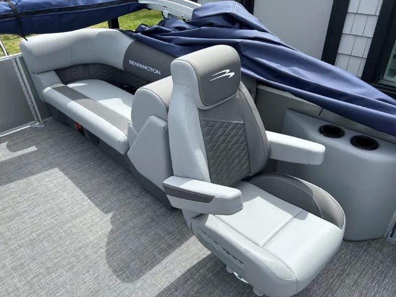 Slide: The Image of 2024 Bennington 22SSRSR boat interior with luxurious gray seating and cup holders. - 8
