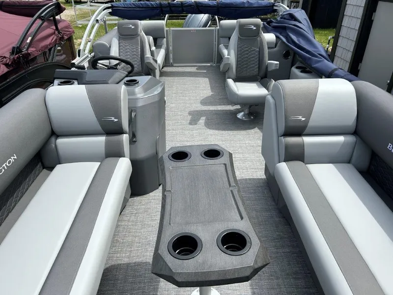 Slide: The Image of 2024 Bennington 22SSRSR pontoon boat interior with gray seating and table. - 9