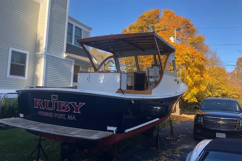 Slide: The Image of 1987 Harris Cuttyhunk Down East boat named "Ruby" on a driveway in autumn setting. - 16