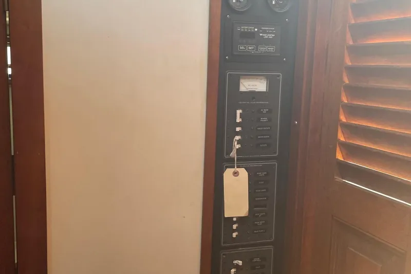 Slide: The Image of Electrical panel inside 1987 Harris Cuttyhunk Down East boat, featuring switches and gauges. - 7
