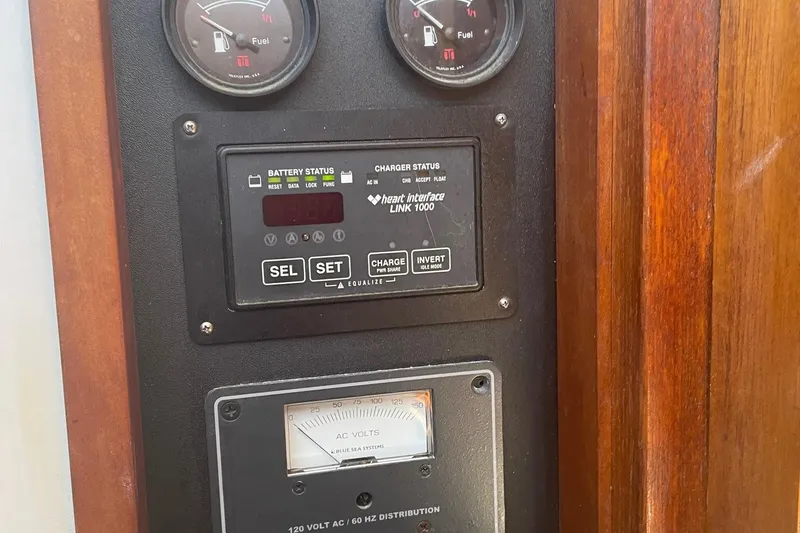 Slide: The Image of Control panel of a 1987 Harris Cuttyhunk Down East boat with gauges and battery status display. - 8