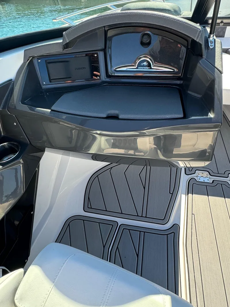 Slide: The Image of 2024 Monterey 218SS boat interior with sleek dashboard and modern flooring design. - 11