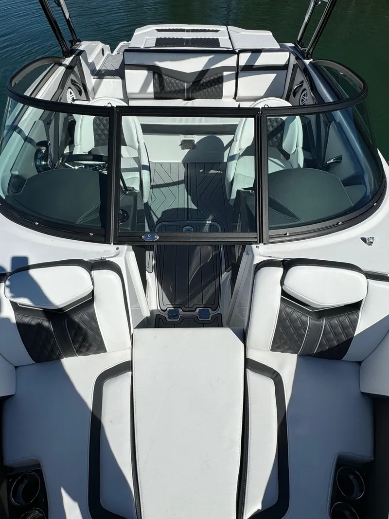 Slide: The Image of 2024 Monterey 218SS boat interior with sleek black and white seating design. - 12