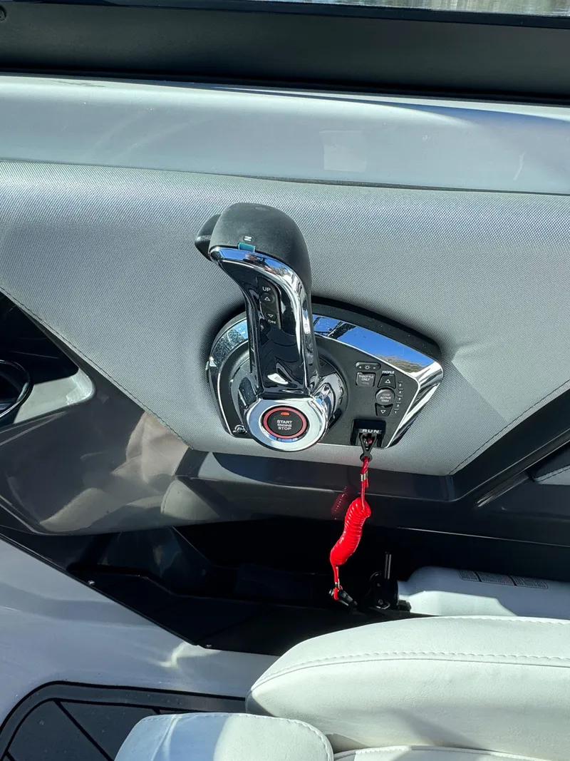 Slide: The Image of 2024 Monterey 218SS boat throttle control with start button and safety lanyard. - 19