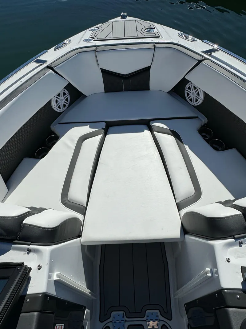 Slide: The Image of 2024 Monterey 218SS boat interior with cushioned seating and cup holders. - 21