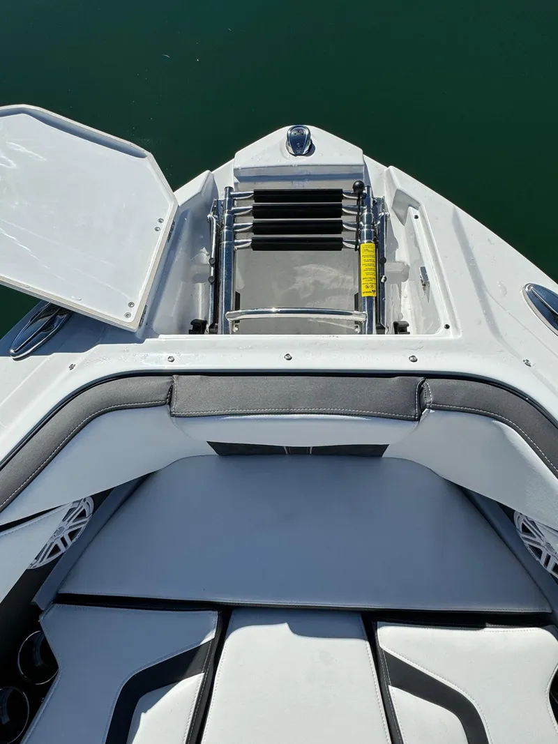 Slide: The Image of 2024 Monterey 218SS boat bow with open storage compartment and ladder. - 22