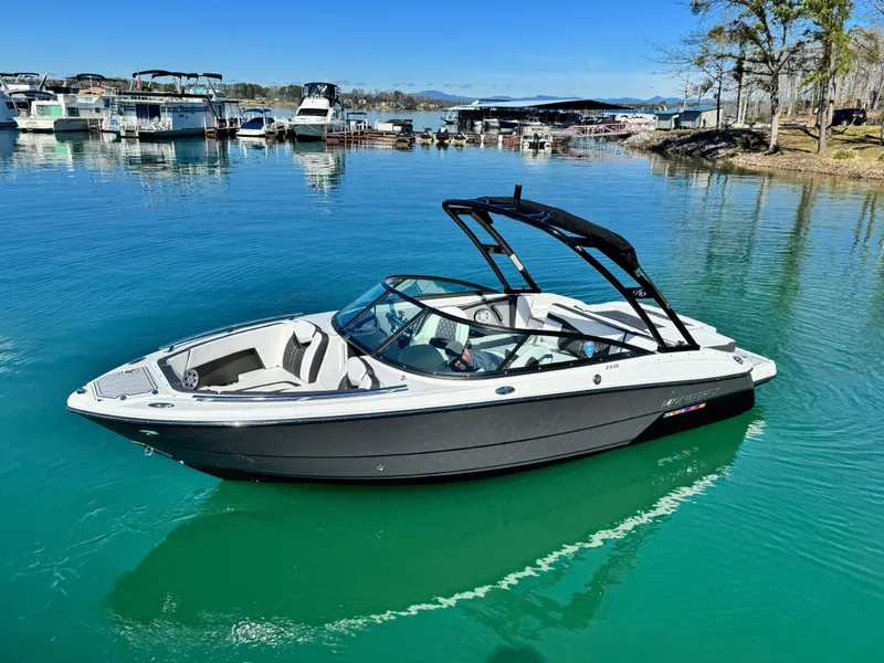 Slide: The Image of 2024 Monterey 218SS boat on clear blue water near a marina. - 3