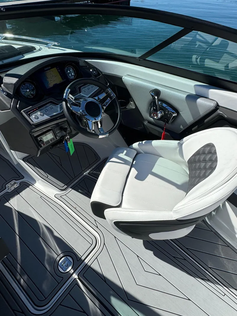 Slide: The Image of 2024 Monterey 218SS boat interior with modern steering and seating. - 8