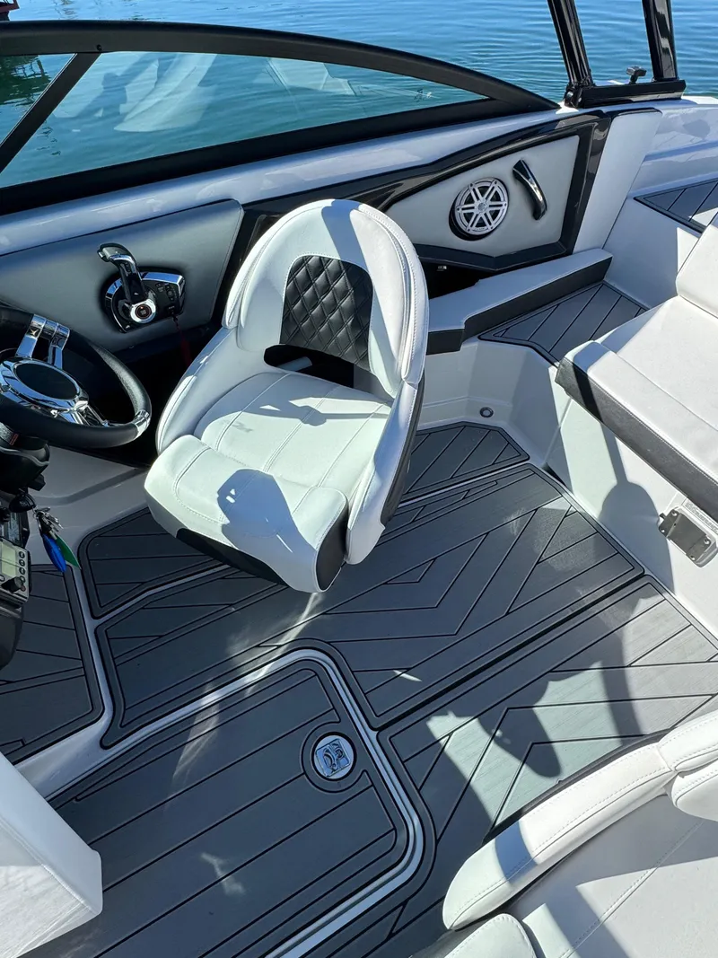 Slide: The Image of 2024 Monterey 218SS boat interior with sleek seating and modern dashboard design. - 9