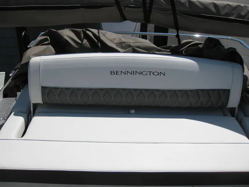 Slide: The Image of 2024 Bennington 25RX Swingback Windshield boat seat with logo and cover. - 11