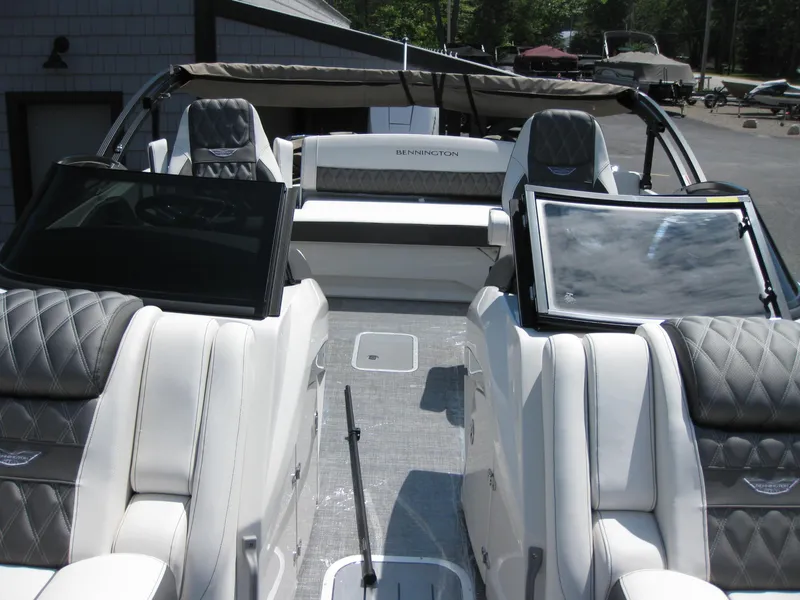 Slide: The Image of 2024 Bennington 25RX Swingback Windshield boat with luxurious seating and sleek design. - 15
