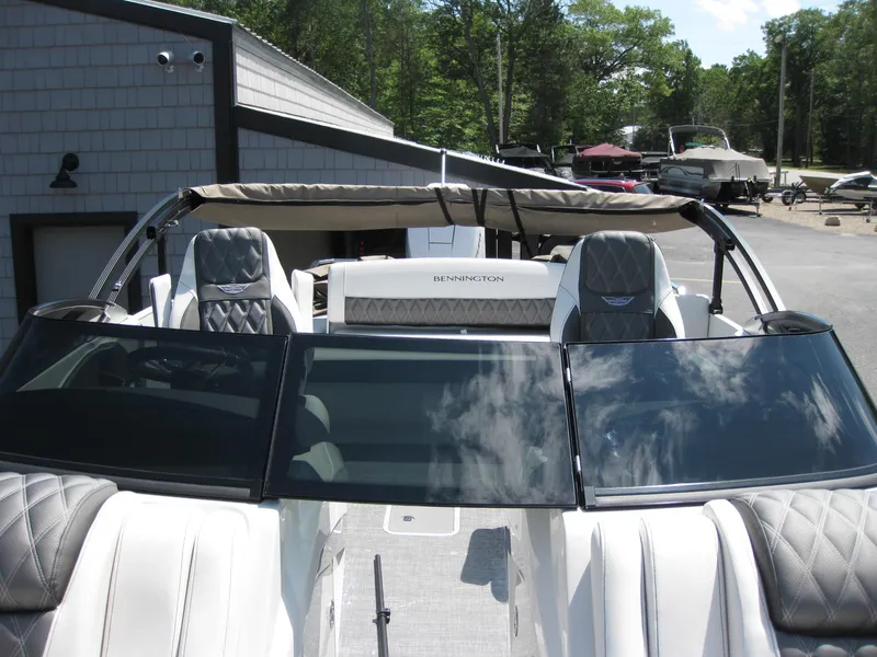 Slide: The Image of 2024 Bennington 25RX Swingback Windshield boat with sleek design and luxurious seating. - 16