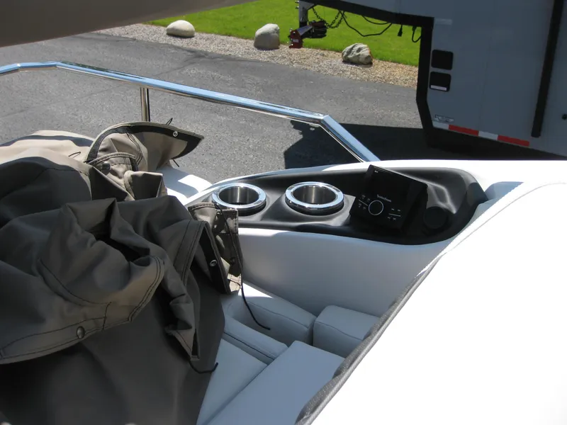 Slide: The Image of 2024 Bennington 25RX Swingback Windshield boat interior with cup holders and control panel. - 18