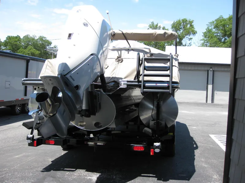 Slide: The Image of 2024 Bennington 25RX Swingback Windshield boat on trailer, rear view. - 3