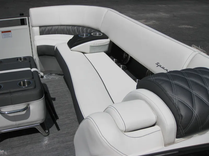 Slide: The Image of 2024 Bennington 25RX Swingback Windshield boat interior with luxurious seating and cup holders. - 7