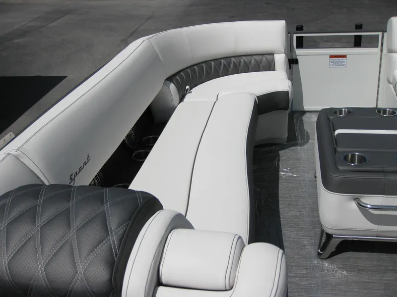Slide: The Image of 2024 Bennington 25RX Swingback Windshield boat interior with luxurious seating and cup holders. - 8