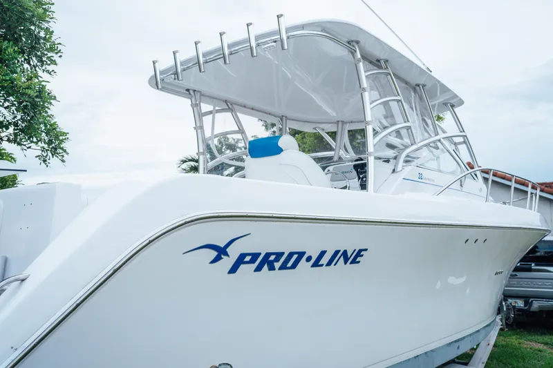 The Image of 2003 Pro-Line 32 Express boat with sleek design and white exterior. - 0