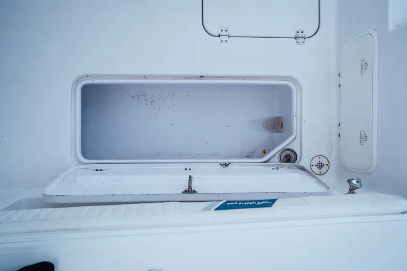 Slide: The Image of Open storage compartment on 2003 Pro-Line 32 Express boat. - 12