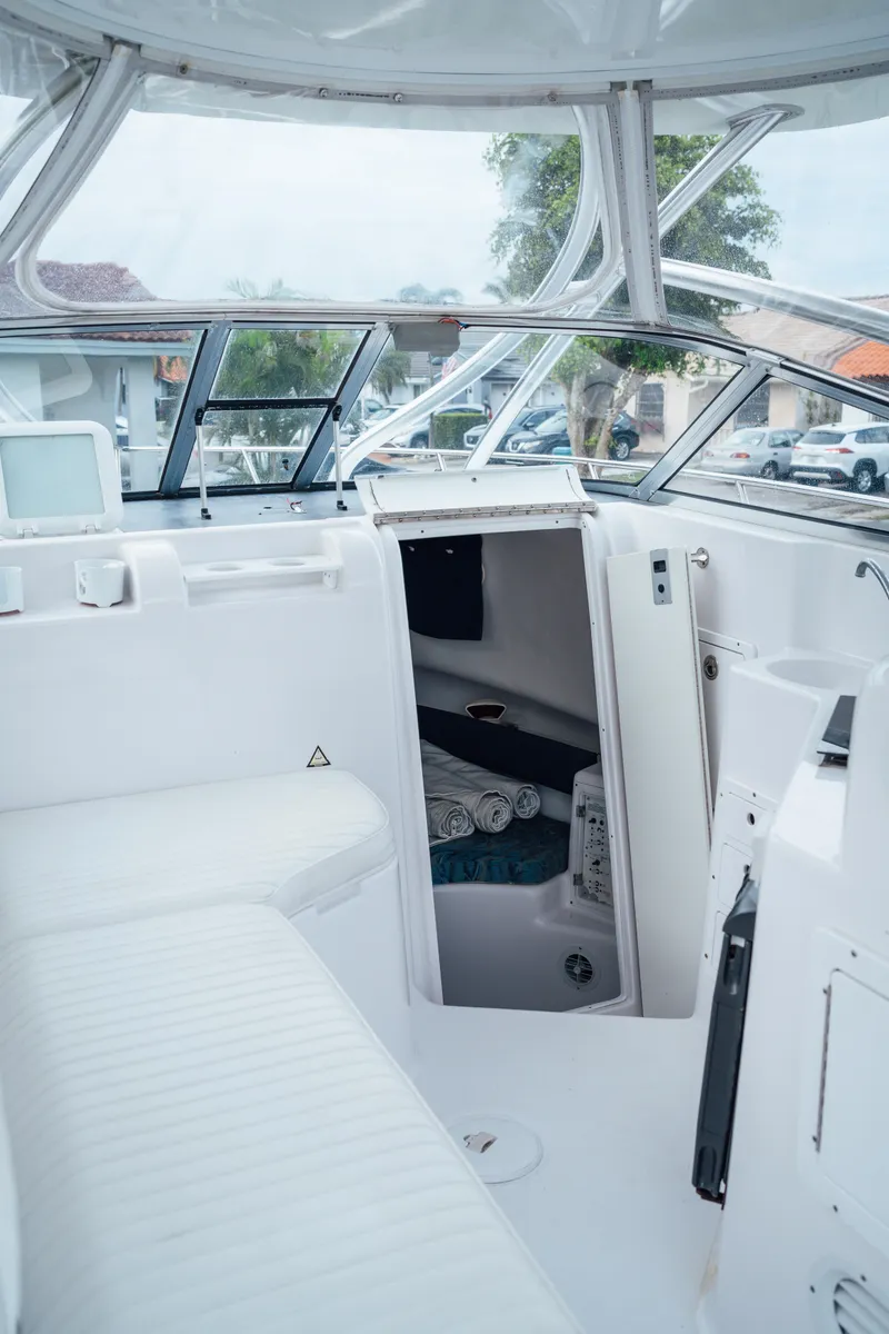 Slide: The Image of 2003 Pro-Line 32 Express boat interior with seating and cabin entrance. - 4