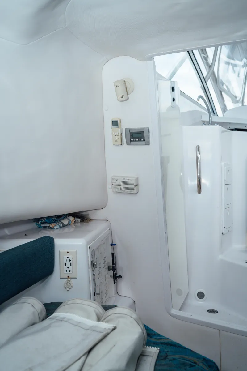 Slide: The Image of Interior of 2003 Pro-Line 32 Express boat, featuring seating and control panel. - 5