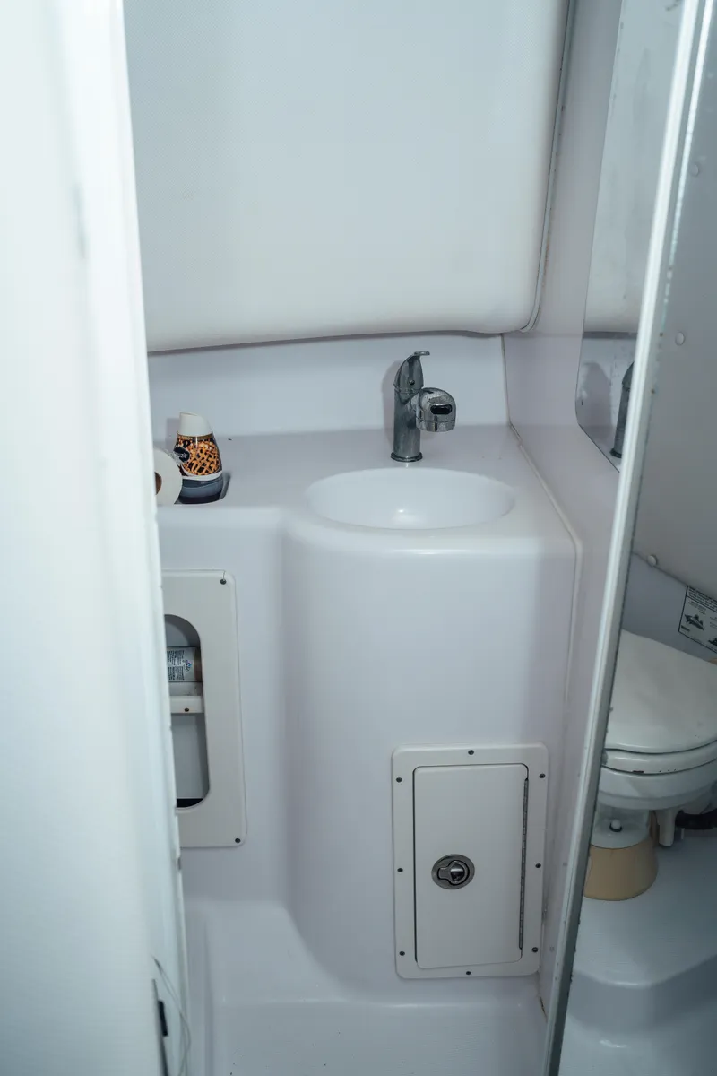 Slide: The Image of 2003 Pro-Line 32 Express boat bathroom with sink and toilet. - 6