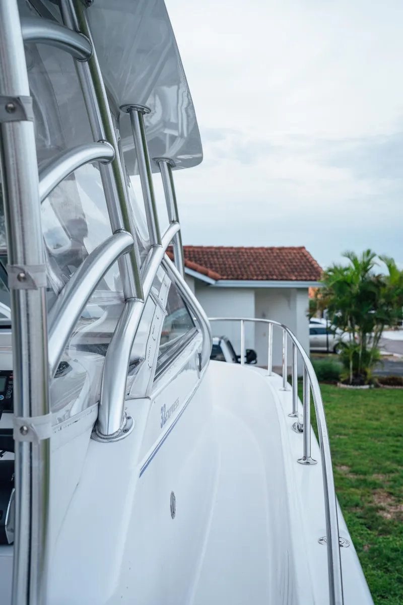 Slide: The Image of 2003 Pro-Line 32 Express boat with sleek design and stainless steel railings. - 9