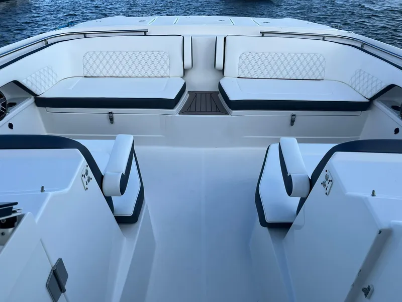 Slide: The Image of 2023 World Cat 400 DC-X boat interior with white seating and blue accents. - 10