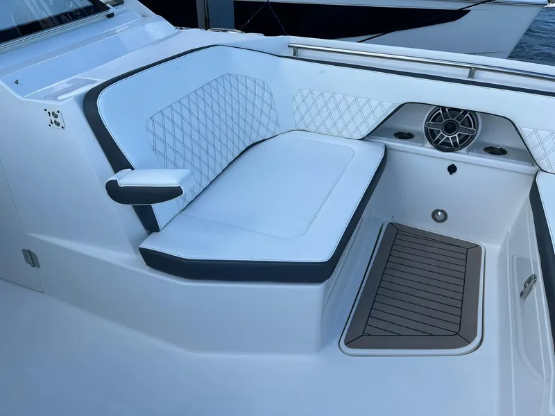 Slide: The Image of 2023 World Cat 400 DC-X boat seating area with cushioned bench and speaker. - 12