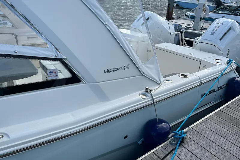 Slide: The Image of 2023 World Cat 400 DC-X boat docked with visible branding and engines. - 14