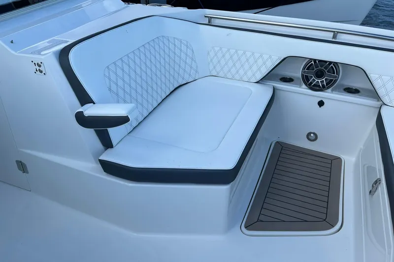 Slide: The Image of Luxurious seating area on 2023 World Cat 400 DC-X boat, featuring speaker and cup holders. - 15