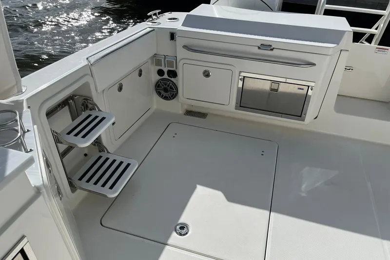 Slide: The Image of 2023 World Cat 400 DC-X boat interior with seating, storage, and stainless steel fixtures. - 17