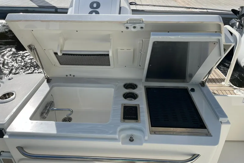Slide: The Image of Outdoor kitchen on 2023 World Cat 400 DC-X boat with sink and grill. - 18