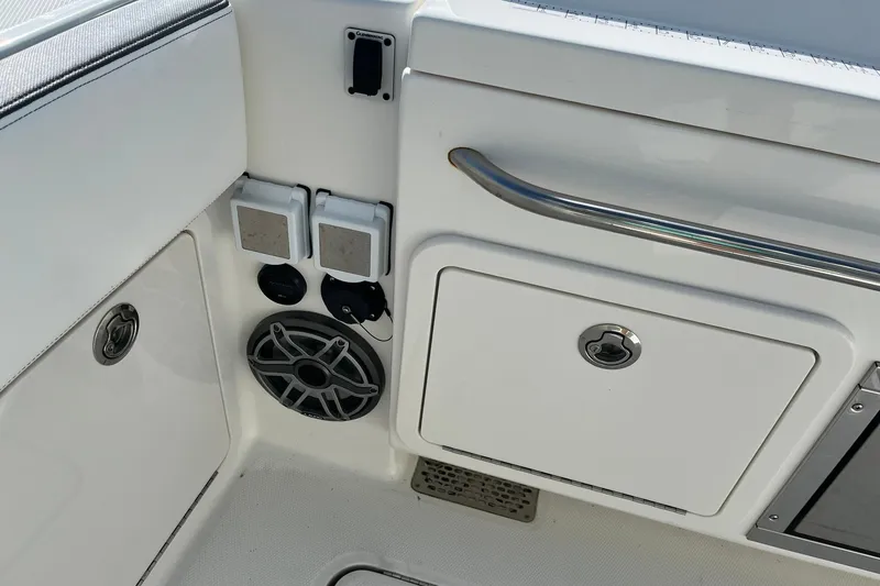 Slide: The Image of 2023 World Cat 400 DC-X boat interior with speaker and storage compartments. - 20