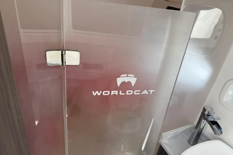 Slide: The Image of 2023 World Cat 400 DC-X bathroom with frosted glass door and modern sink. - 22