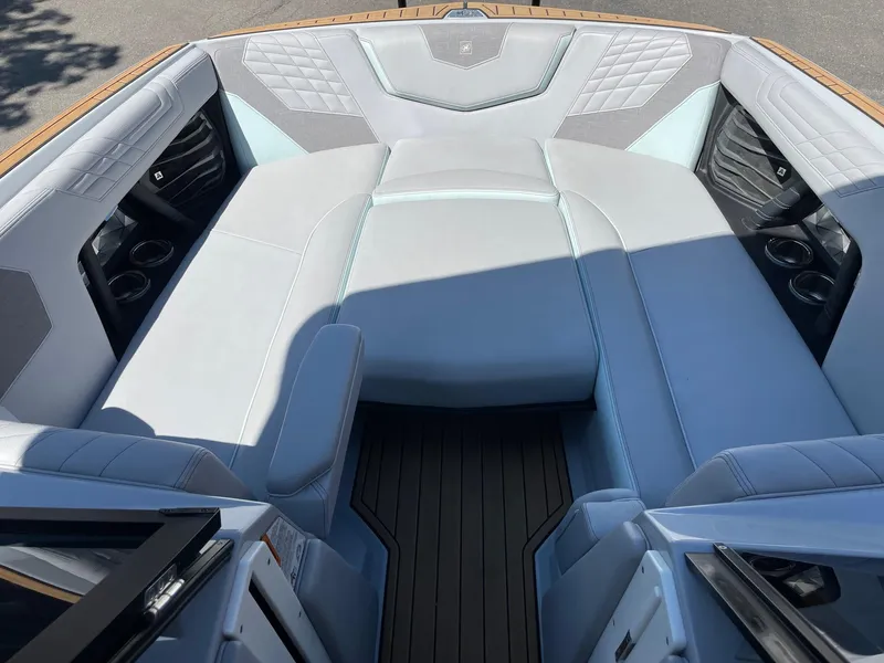 Slide: The Image of 2022 Nautique Super Air Nautique G25 interior with luxurious seating and cup holders. - 12