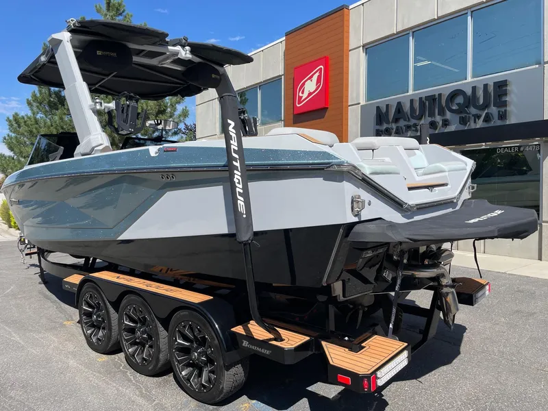 Slide: The Image of 2022 Nautique Super Air Nautique G25 boat on trailer outside dealership. - 3