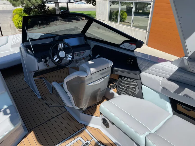 Slide: The Image of 2022 Nautique Super Air Nautique G25 boat interior with modern dashboard and seating. - 7