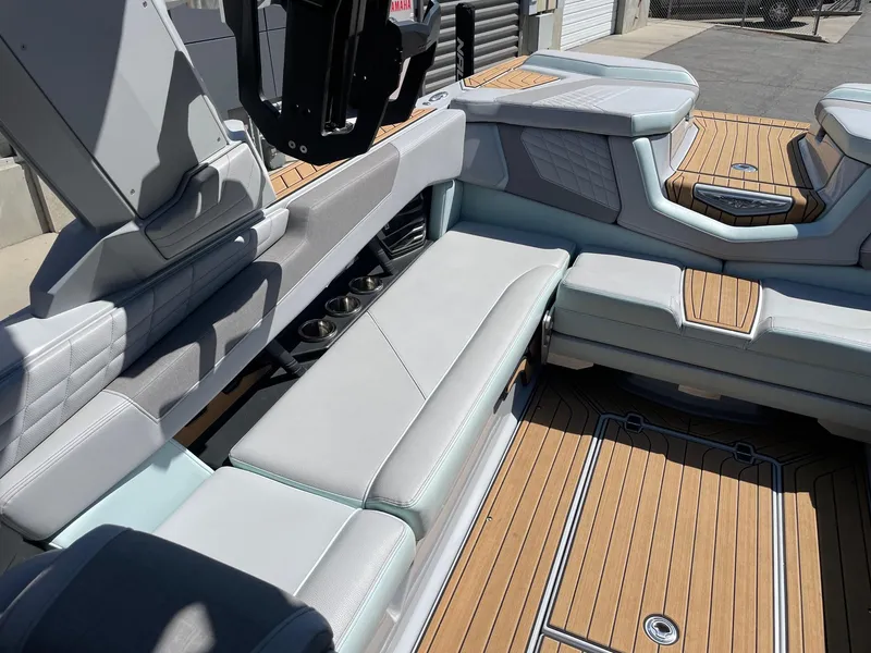 Slide: The Image of 2022 Nautique Super Air Nautique G25 interior with luxurious seating and teak flooring. - 8