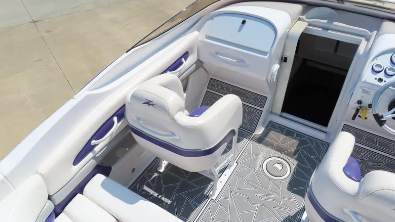Slide: The Image of 2003 Donzi 28 ZX Open boat interior with white and purple seating, modern dashboard. - 12