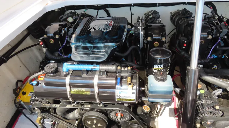 Slide: The Image of Engine compartment of a 2003 Donzi 28 ZX Open boat, showcasing detailed mechanical components. - 23