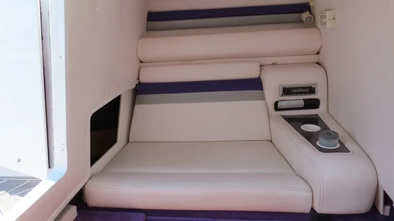 Slide: The Image of 2003 Donzi 28 ZX Open cabin interior with cushioned seating and storage. - 28