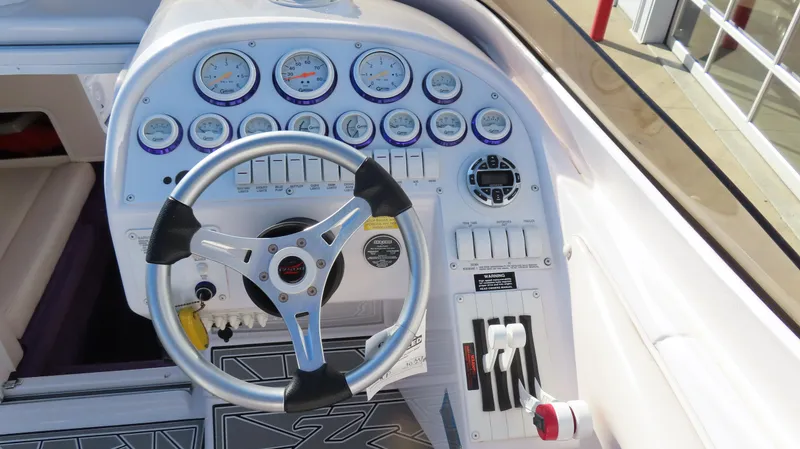 Slide: The Image of 2003 Donzi 28 ZX Open boat dashboard with steering wheel and gauges. - 33