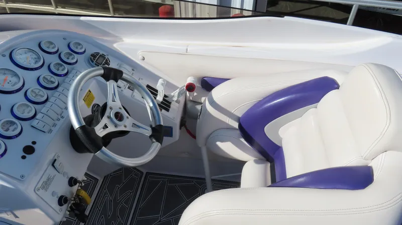 Slide: The Image of 2003 Donzi 28 ZX Open cockpit with gauges and white-purple seating. - 35