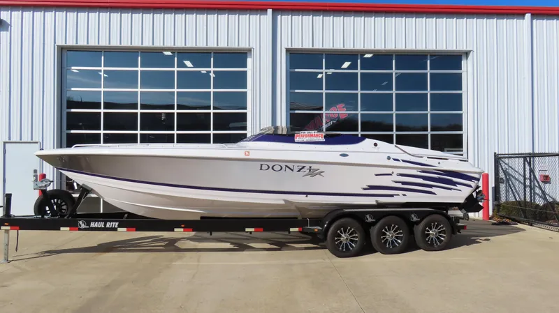 Slide: The Image of 2003 Donzi 28 ZX Open speedboat on trailer outside a garage. - 40