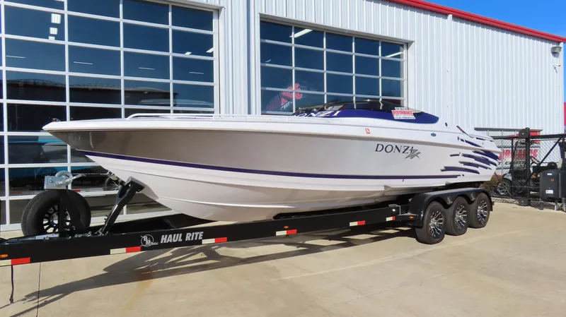 Slide: The Image of 2003 Donzi 28 ZX Open speedboat on trailer outside a garage. - 41