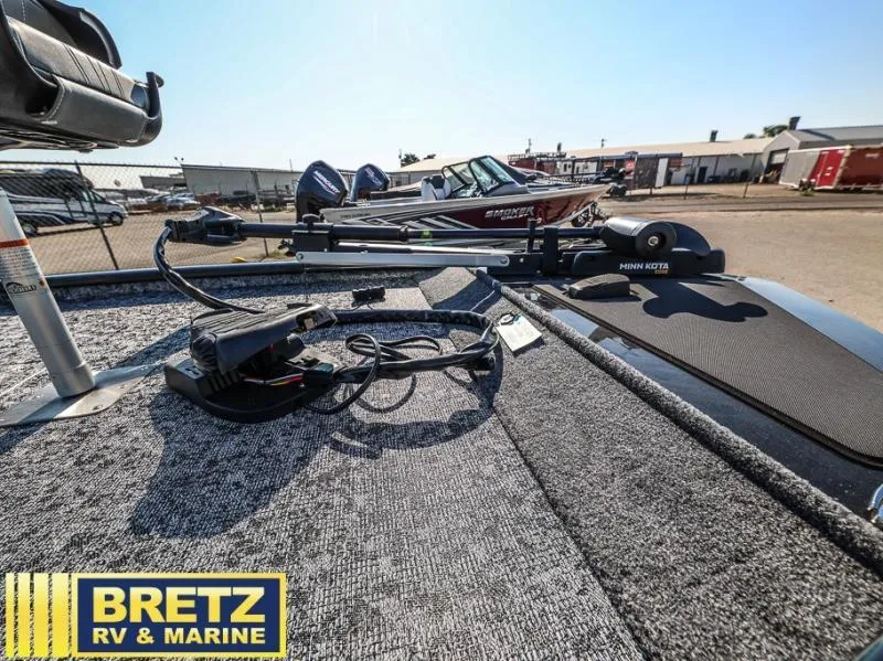 Slide: The Image of Fishing boat deck with Minn Kota trolling motor, Bretz RV & Marine logo, sunny day. - 11