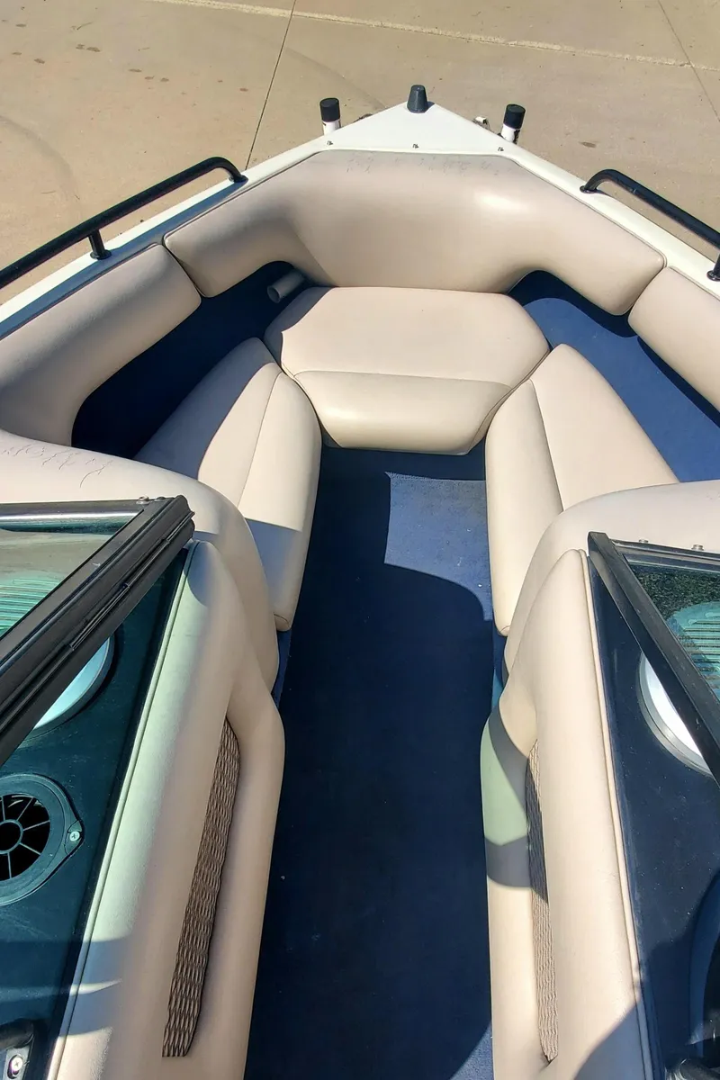 Slide: The Image of 2000 Calabria Sport Comp XTS boat interior with beige seating and blue flooring. - 4