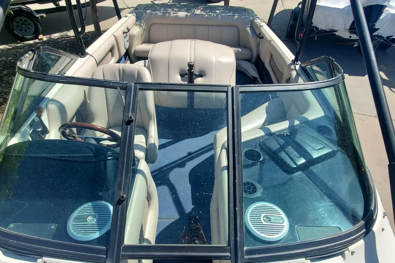 Slide: The Image of 2000 Calabria Sport Comp XTS boat interior with beige seating and dual speakers. - 5