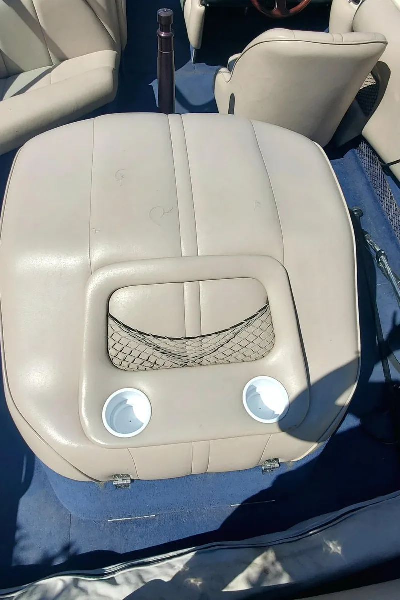 Slide: The Image of 2000 Calabria Sport Comp XTS boat interior with beige seating and cup holders. - 6